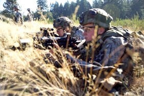 Two Soldiers in combat gear 